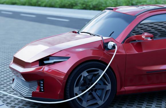 Electric car plugged into charging station