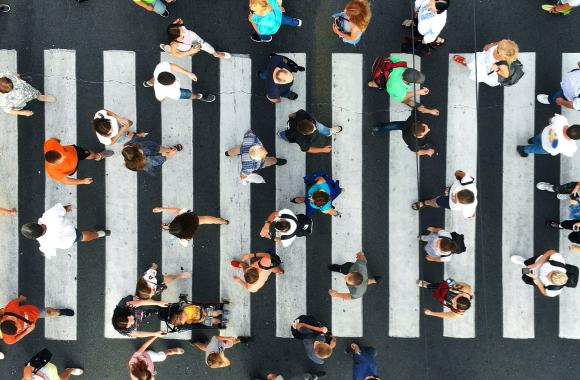Many people in a crosswalk viewed from above